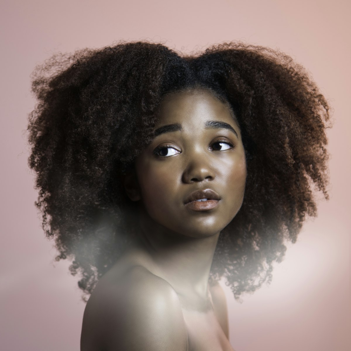 A client with a fresh afro style after a salon appointment