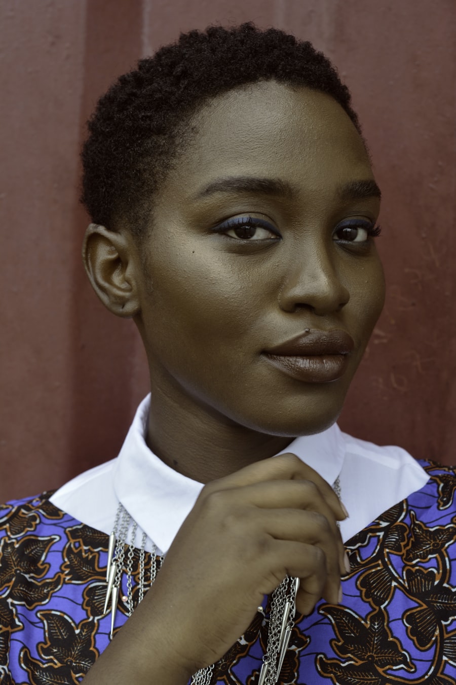 A client in Ankara print with makeup and braids styled by a GLAM-Connect professional