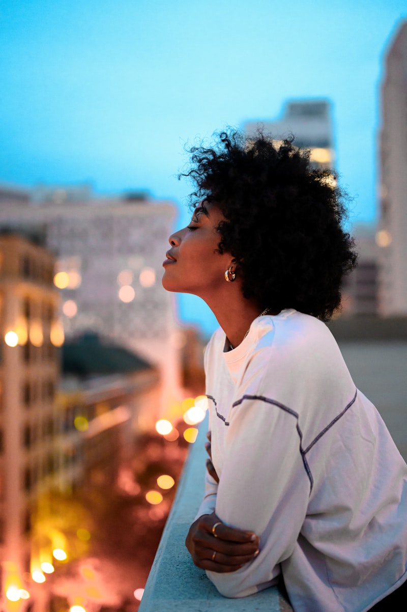 A beauty professional standing against the Johannesburg skyline at dusk